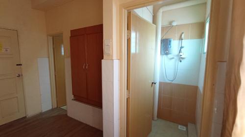 a bathroom with a shower and a toilet in it at Straits Settlement Inn in Melaka