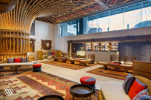 a lobby with couches and tables in a building at Mandala Hotel & Spa Phú Yên - 24hours Stay in Tuy Hoa