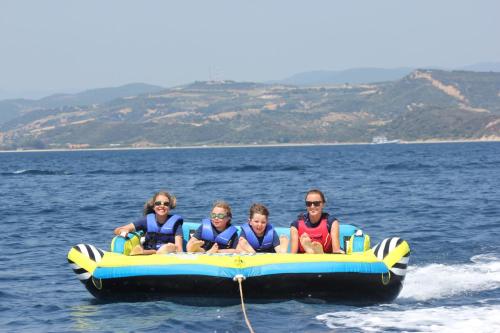 a group of people riding on a boat in the water at Eagles Palace in Ouranoupoli