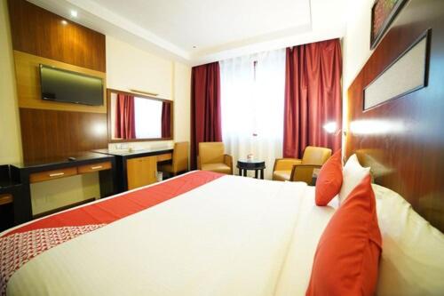 a hotel room with a bed and a television at Sun And Sands Downtown in Dubai