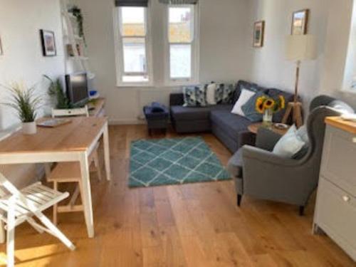 a living room with a couch and a table at Flat 6 George Street in Teignmouth