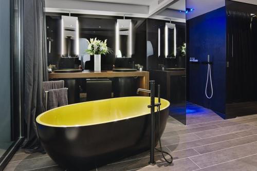 a yellow bath tub in a bathroom with a bar at Charo - San Jose in Sant Josep de sa Talaia