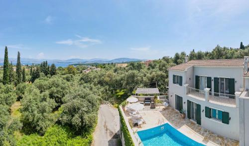 an aerial view of a house with a swimming pool at Villa Leveque - Kassiopi Hillside pool villa in Kassiopi