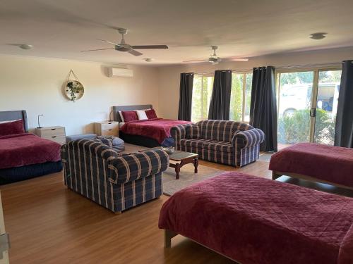 a living room with a bed and a couch and chairs at Austral Place 88 via Merri River in Warrnambool