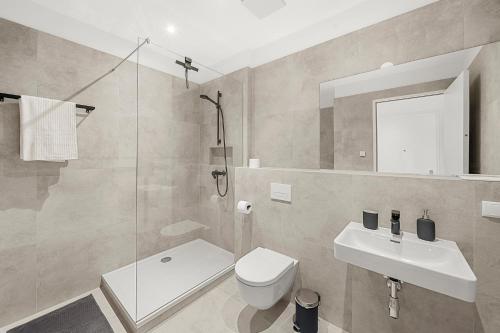 a bathroom with a toilet and a sink and a shower at VibeStudio B2 - Central Vienna 1090 - 50m2 - Self Check-In - AC in Vienna