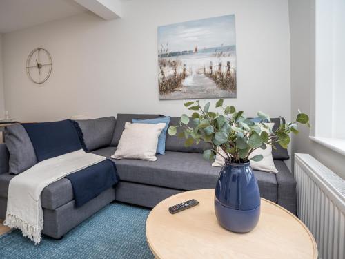 a living room with a gray couch and a table at The Views Townhouse in Newcastle