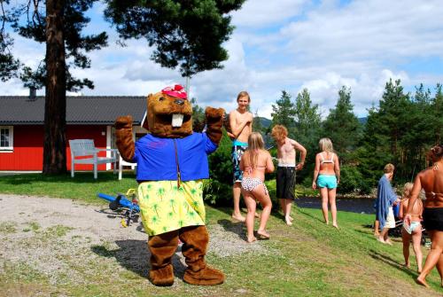 a person in a bear costume standing in a group of people at Beverøya Hytteutleie og Camping in Bø