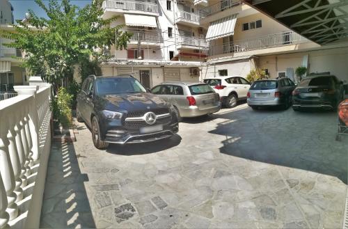 a car parked in a parking lot next to a building at Emmanuel Apartments in Paralia Katerinis