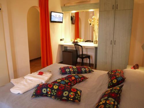a bedroom with a bed with pillows on it at Club Esse Cala Bitta in Baja Sardinia