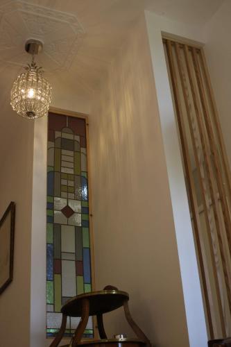 a room with a table and a stained glass window at Malis Castera Le Petit Château in Saint-Jean-de-Blaignac