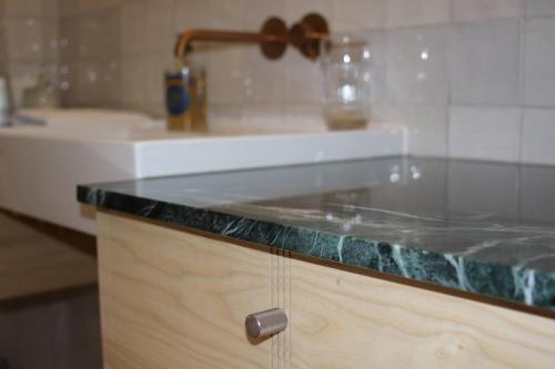a bathroom with a sink and a counter top at Malis Castera Le Petit Château in Saint-Jean-de-Blaignac