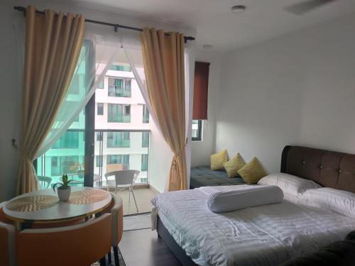 a bedroom with a bed and a table and a couch at Nur Mateen's Studio - Vista Bangi Service Apartment in Kajang