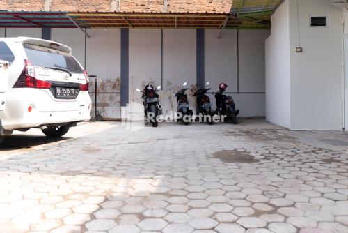 a group of motorcycles parked in a garage at Wisma Narada 2 Lampung Mitra RedDoorz in Tanjungkarang