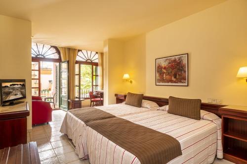 a bedroom with a large bed in a room at Hotel Guitart Rosa - Adults Only in Lloret de Mar