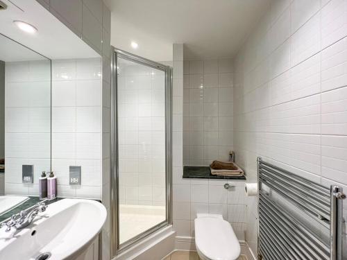 a bathroom with a sink and a toilet and a mirror at Discounted Two Bed Apartment In The Heart Of Soho in London