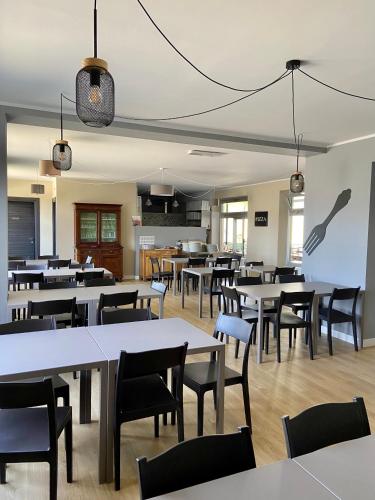 an empty dining room with tables and chairs at Hotel La Pace in San Mauro Torinese