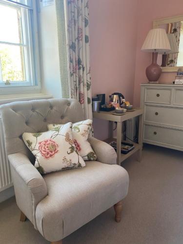 a living room with a couch with pillows and a table at The Seagrave Arms in Weston Subedge