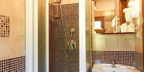 a bathroom with a shower and a sink at La Locanda Del Lago Lucciola in Villalago