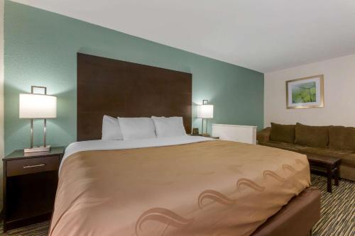 a hotel room with a large bed and a couch at Quality Inn Alexis Rd in Toledo