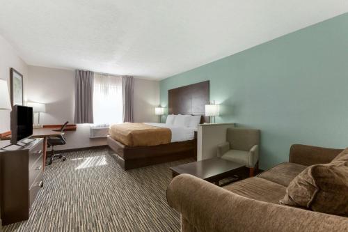 a hotel room with a bed and a couch at Quality Inn Alexis Rd in Toledo