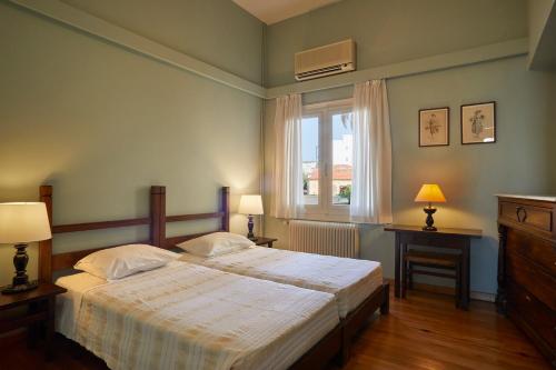 a bedroom with a large bed and a window at Doma Hotel in Chania