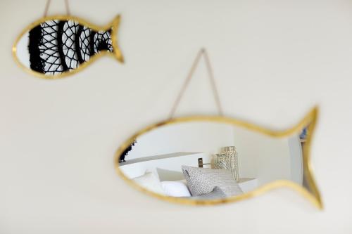 a mirror with a reflection of a room at Eagles Villas - Small Luxury Hotels of The World in Ouranoupoli