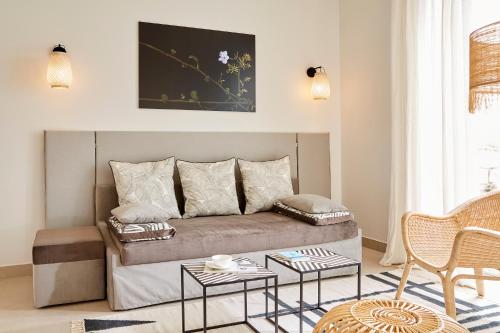 a living room with a couch and a table at Eagles Villas - Small Luxury Hotels of The World in Ouranoupoli
