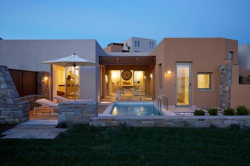 a house with a swimming pool in the yard at Eagles Villas - Small Luxury Hotels of The World in Ouranoupoli