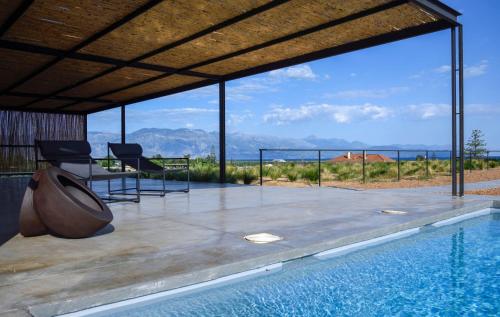 a house with a swimming pool with a view at Bouca Houses in Messini