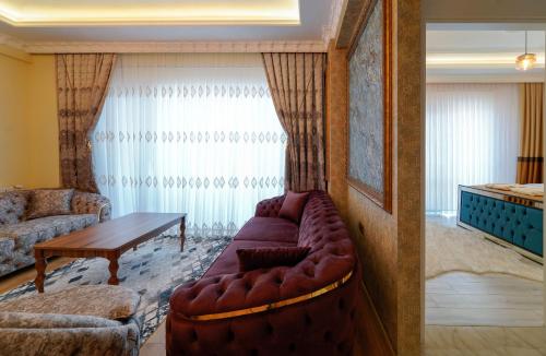 a living room with a couch and a table at Pearl of Cappadocia in Avanos