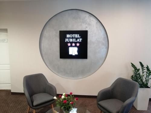 a room with two chairs and a sign that reads hotel lobby at Hotel Jubilat in Zamość