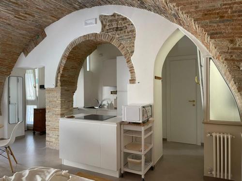 a kitchen with an archway with a microwave in it at Residenze Aimone in Vasto