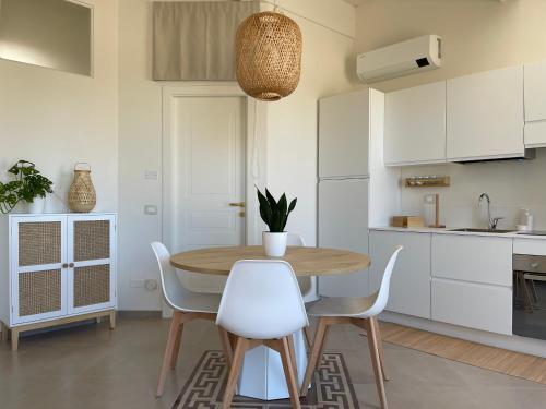 a kitchen and dining room with a wooden table and chairs at Residenze Aimone in Vasto