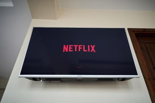 a television on a wall with the netflix sign on it at LP Luxury Suite - Old Town Xanthi in Xanthi