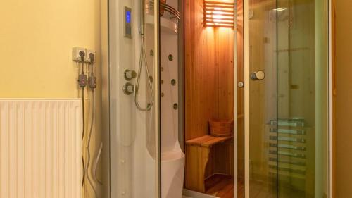 a bathroom with a shower and a glass shower stall at Captain Alex Villa 2 in Dafnila