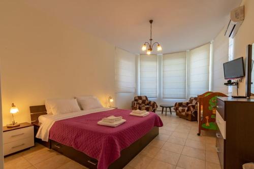 a bedroom with a bed and a living room at Captain Alex Villa 2 in Dafnila