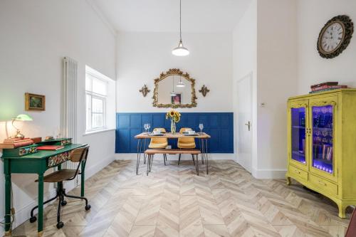 a dining room with a table and a yellow cabinet at Entire 2 Bed Flat Plaistow,Canning town Prime Location in London in London