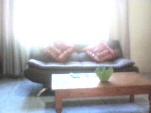 a living room with a couch and a coffee table at M AND M HOME FROM HOME in Port Edward