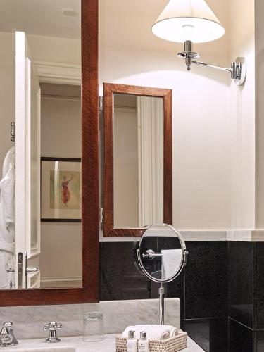 a bathroom with a sink and a mirror at La Tremoille Paris in Paris