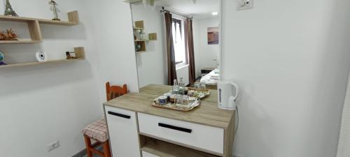 a kitchen with a wooden counter next to a refrigerator at Dumi's House in Borşa