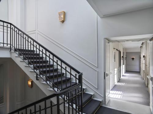 a staircase in a building with black seats at J.K. Place Roma - The Leading Hotels of the World in Rome