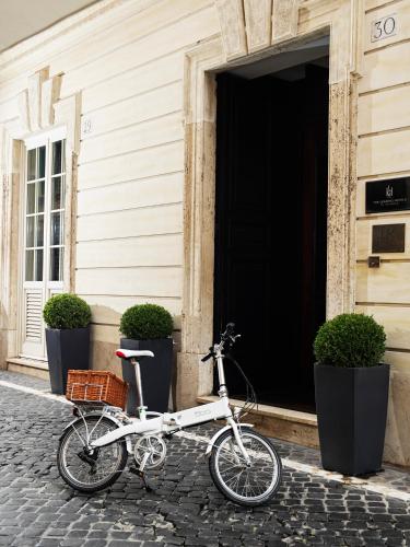 a white bike parked in front of a building at J.K. Place Roma - The Leading Hotels of the World in Rome