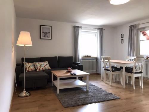 a living room with a couch and a table at Ferienwohnungen Rössle in Stiefenhofen