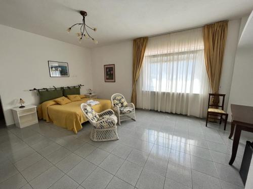 a bedroom with a bed and a table and chairs at Villa Loreta in Ischia