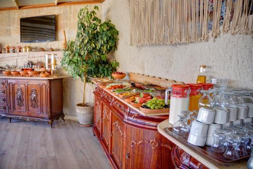 a kitchen with a counter with food on it at Amber Cave Suites in Goreme