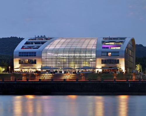 a large building next to a body of water at Kameha Grand Bonn in Bonn
