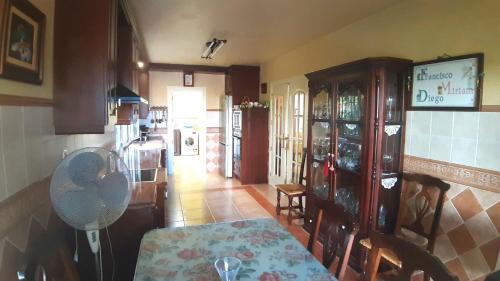 a kitchen with a table and a dining room at Villa Granada Motril in Motril