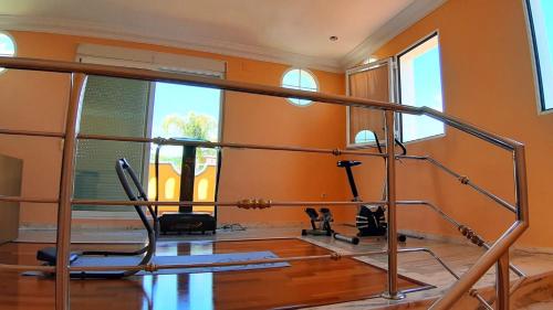a gym with a treadmill and a chair in a room at Villa Granada Motril in Motril