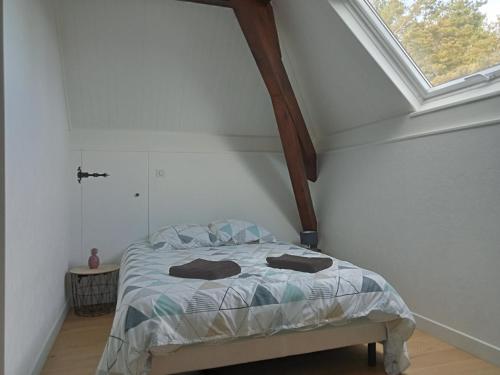 a bedroom with a bed in a room with a window at Vaste villa en position dominante superbe vue lacs in Hautecour