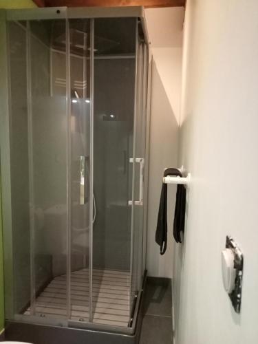 a shower stall with a glass door in a bathroom at Vaste villa en position dominante superbe vue lacs in Hautecour